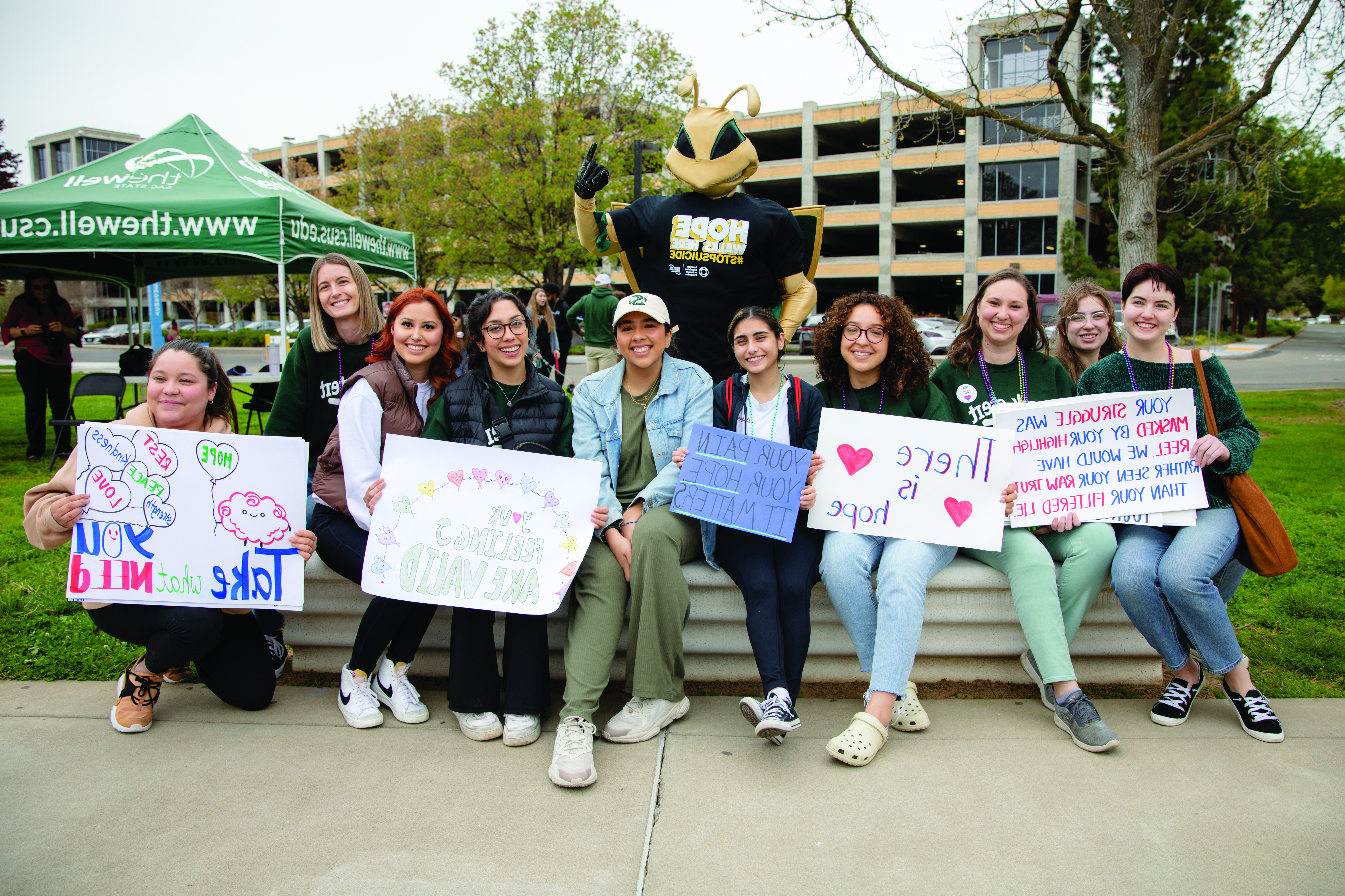 Photo: students holding signs at suicide prevention event