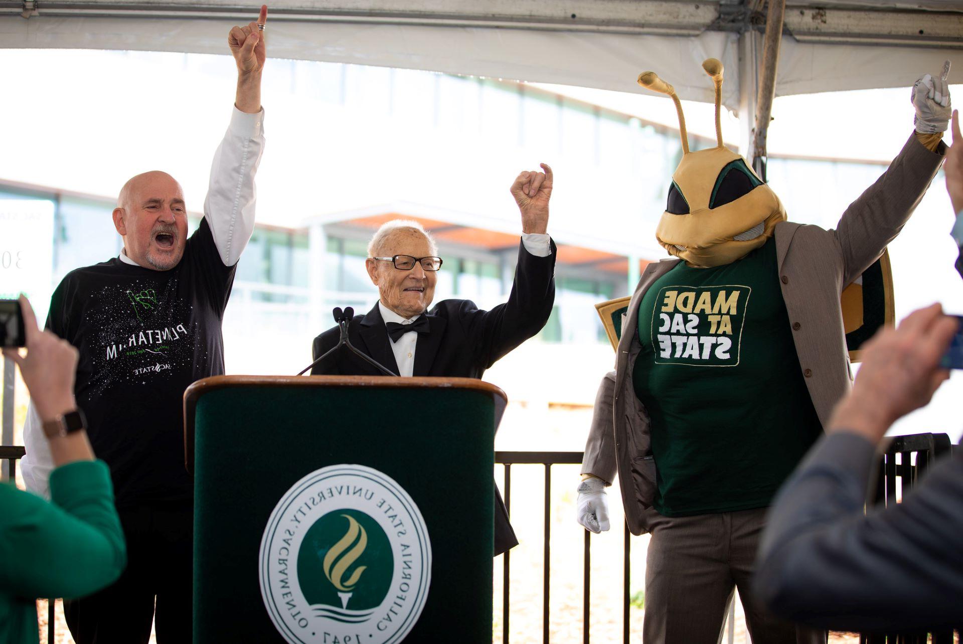 Herky, Ernest Tschannen, and President Robert Nelsen doing "Stingers Up!