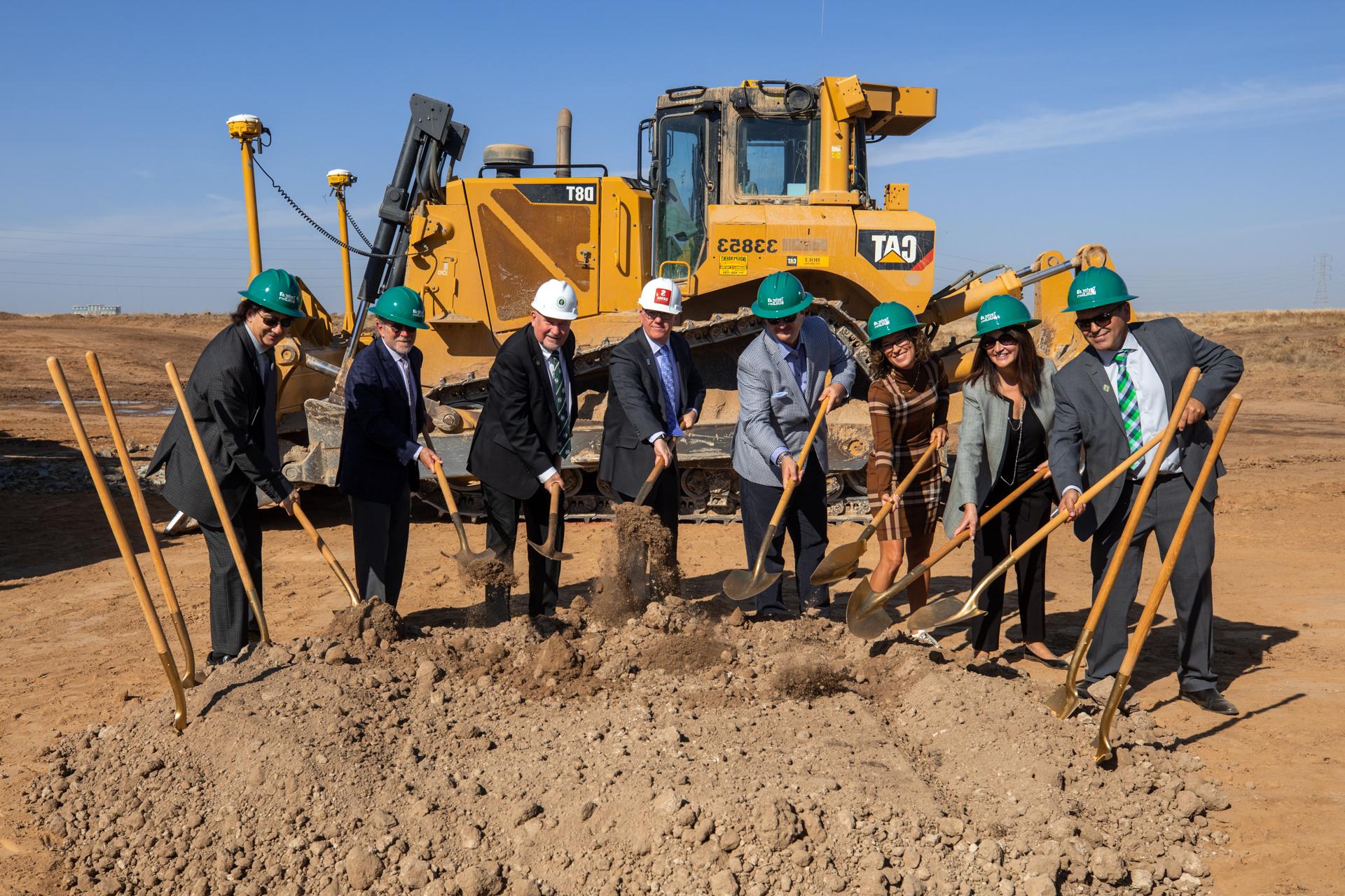 President Nelsen with other officials holding shovels at groundbreaking